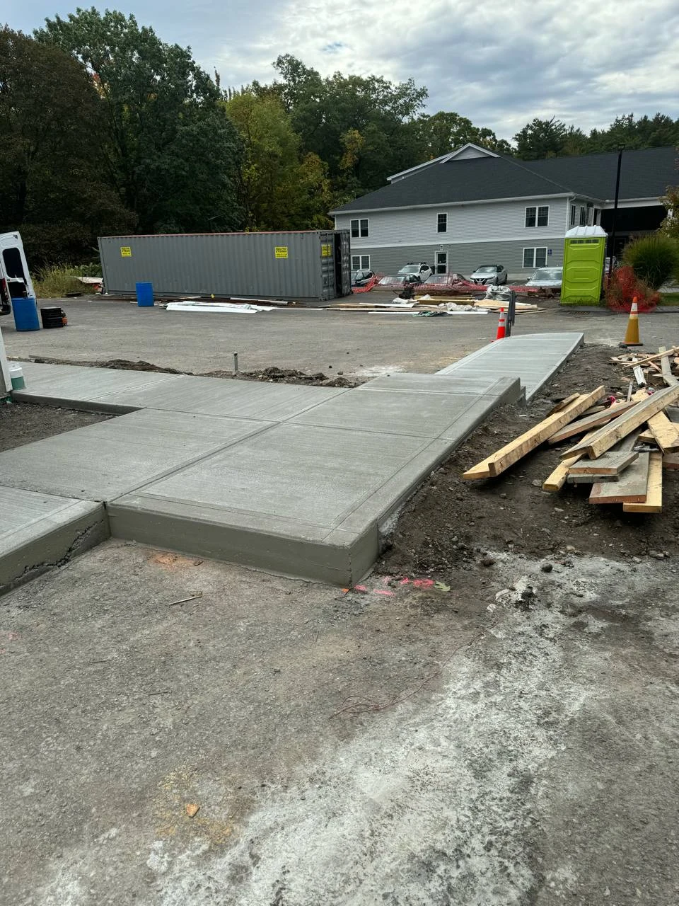 Finished concrete walkway with straight edges and neatly spaced joints at a job site